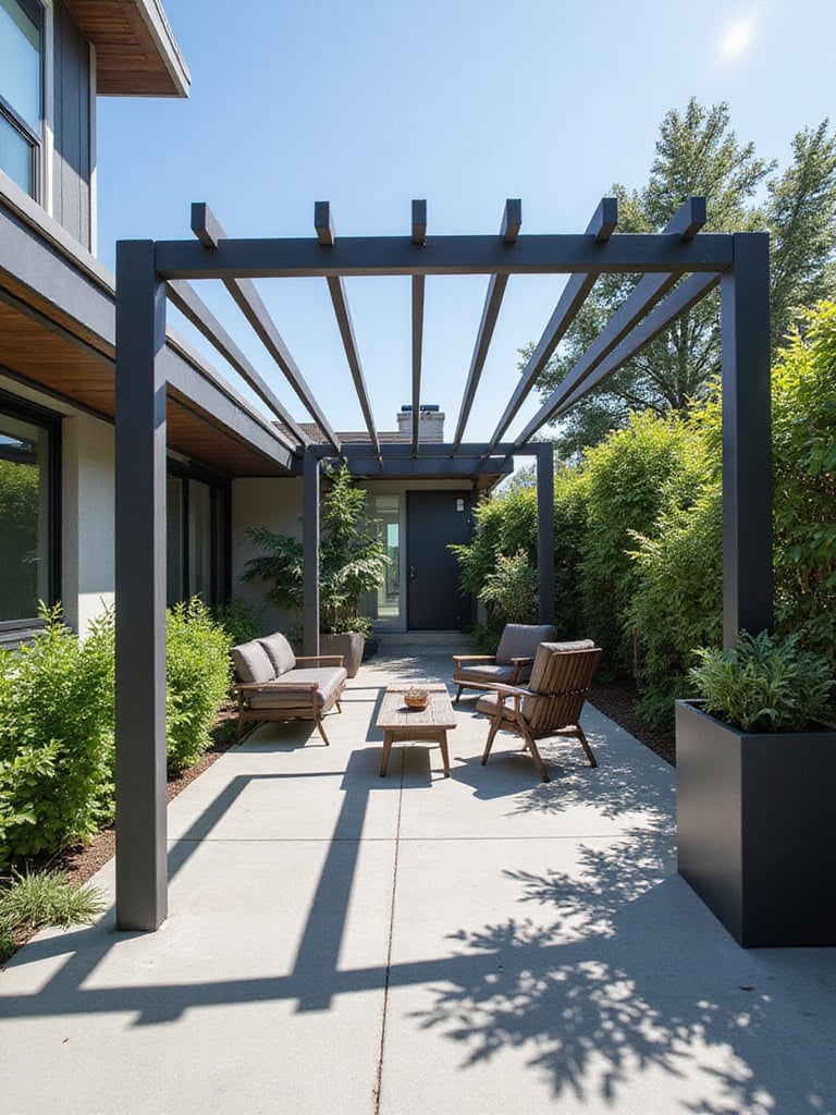 Modern patio with a dark gray steel pergola providing shade over concrete pavers and contemporary outdoor furniture.