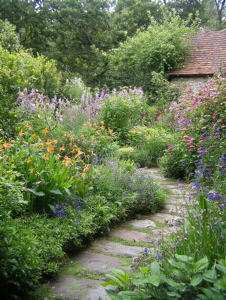 High-quality ergonomic gardening tools arranged on a wooden bench in a garden setting showcasing angled handles and cushioned grips