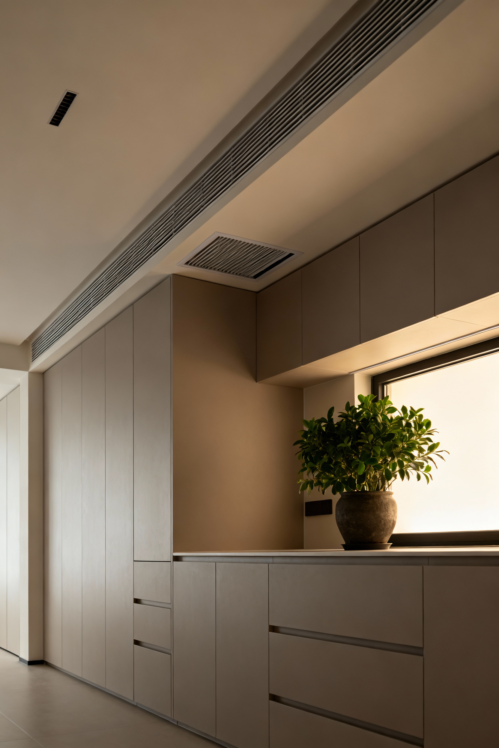 A pristine, minimalist luxury laundry room showcasing discreet HVAC vents, advanced air quality features, and elegant design for optimal comfort and textile preservation.