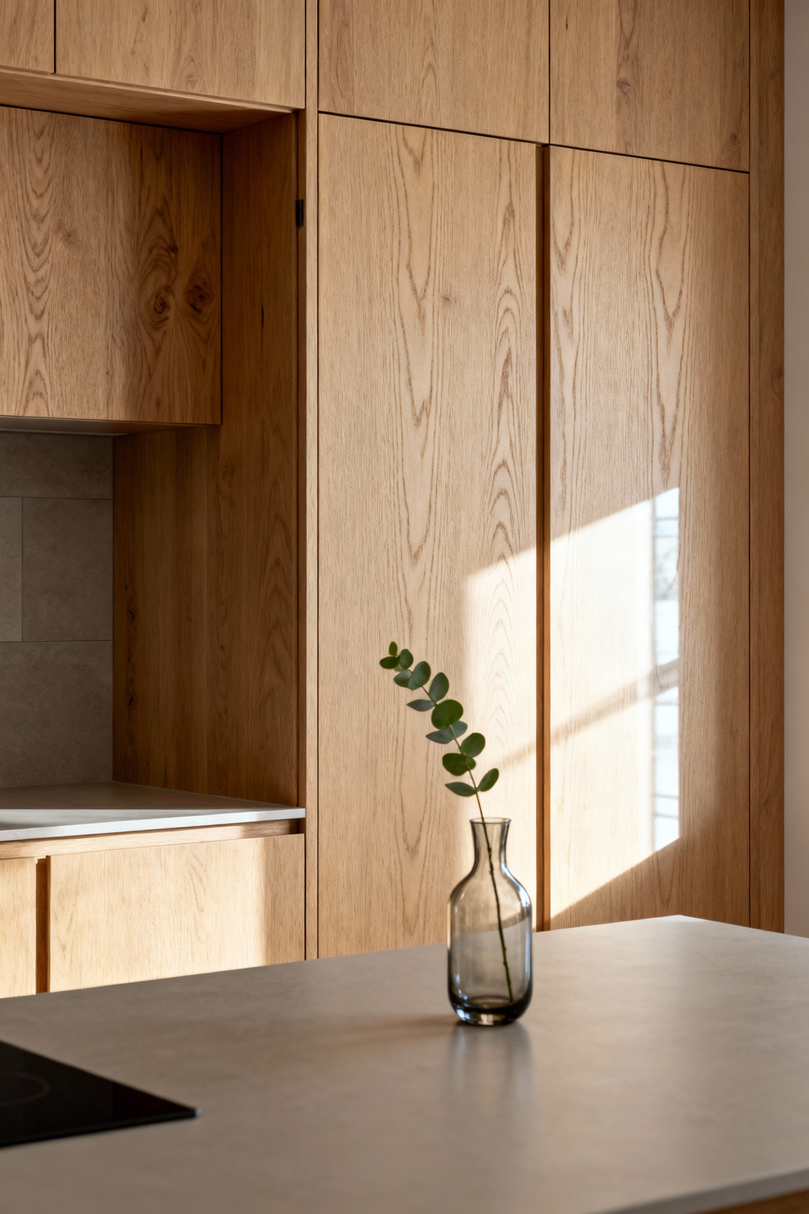 Modern kitchen cabinet detail showcasing light-toned, rift-sawn European white oak with natural hardwax oil finish, emphasizing sustainable materials and fine craftsmanship.